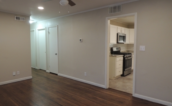 Living room looking to hallway and kitchen